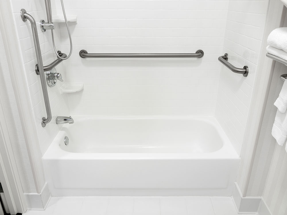 Image of a bathtub & shower with grab bars for handicap access