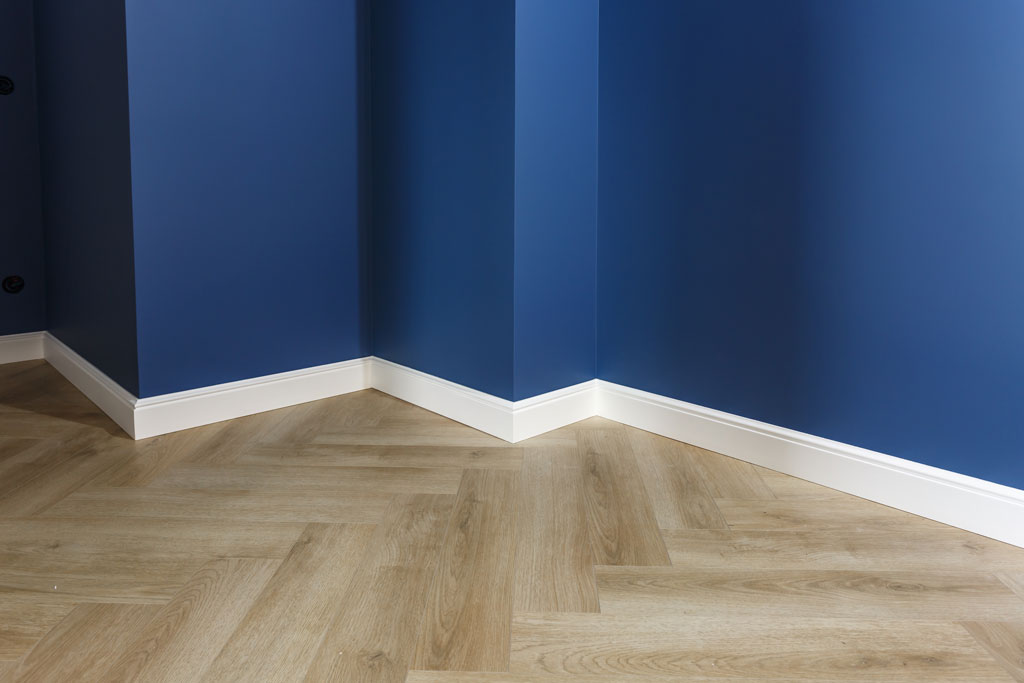 Interior Image of a blue painted wall and white trim