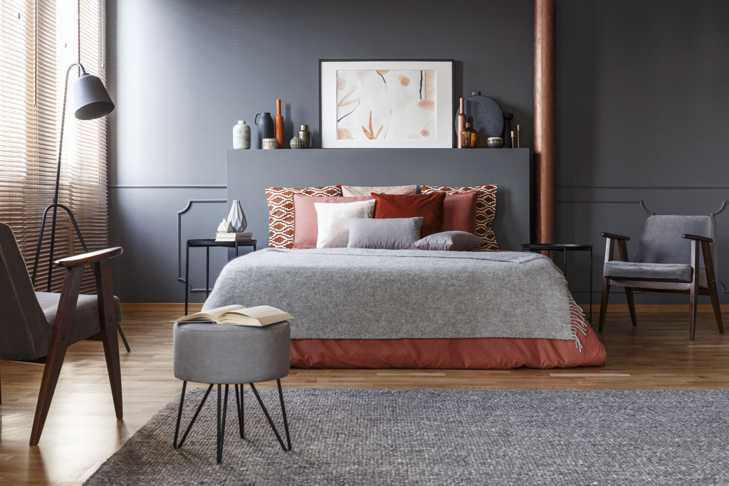 Image of a bedroom with dark and neutral colors