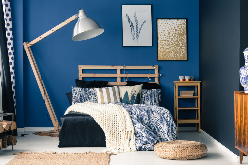 Image of a bedroom painted with a cool color and decor.