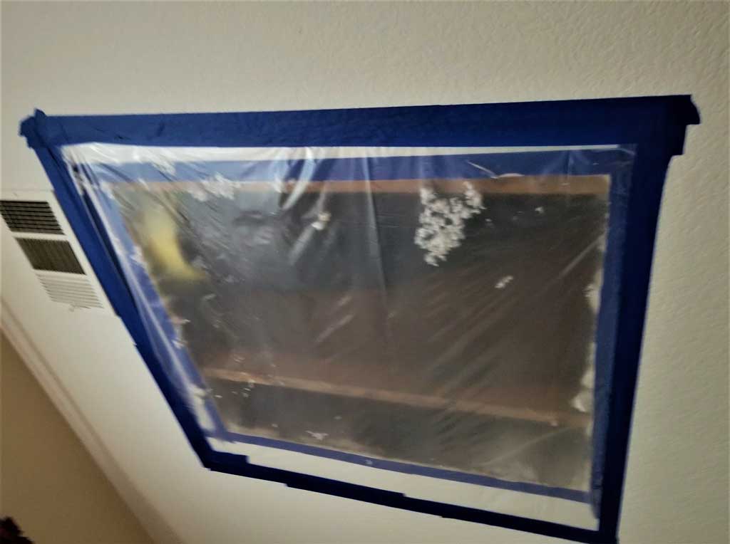 Image of a section of drywall ceiling removed after fixing water leak